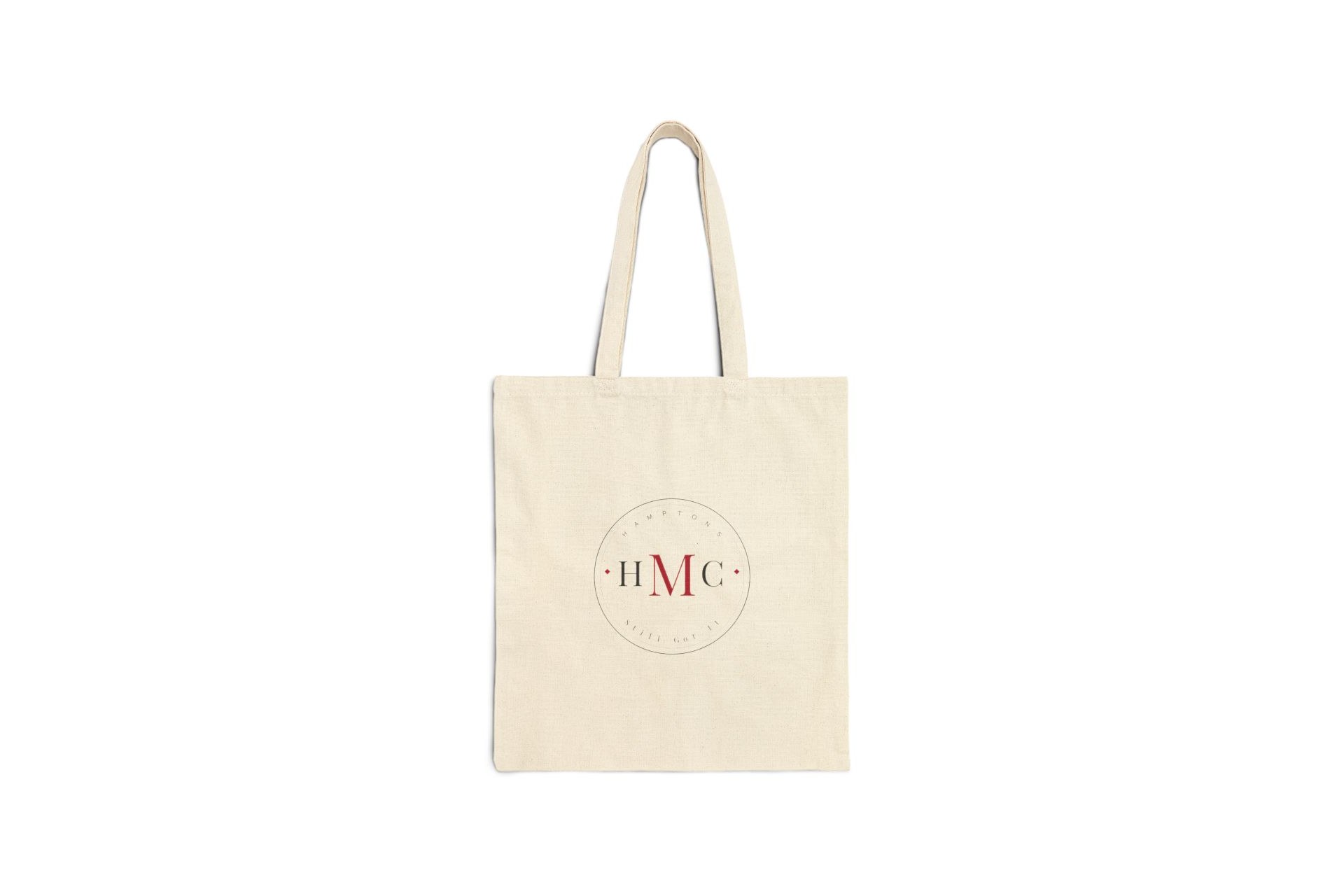 Natural canvas tote bag with a black and crimson HMC Hamptons circular badge graphic
